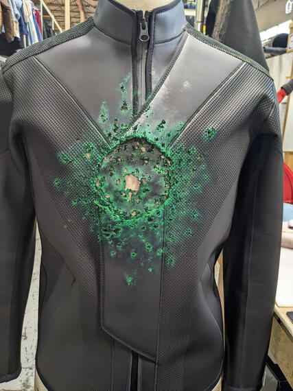 Kryptonite impact fx on Superboy coated neoprene jacket for Superman and Lois s3